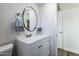 Updated bathroom with white vanity and a large round mirror at 1531 W Colter St # 7, Phoenix, AZ 85015