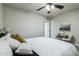 Spacious bedroom with ceiling fan, neutral walls, and plush bedding at 1531 W Colter St # 7, Phoenix, AZ 85015