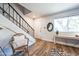 Entryway with wood-look floors, a wicker chair, and staircase at 1531 W Colter St # 7, Phoenix, AZ 85015