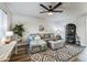 Living room featuring a gray sectional sofa and a ceiling fan at 1531 W Colter St # 7, Phoenix, AZ 85015