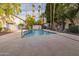 Refreshing community pool area with surrounding trees at 1531 W Colter St # 7, Phoenix, AZ 85015