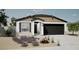 One-story home with dark brown garage door and landscaping at 18070 W Cielo Grande Ave, Surprise, AZ 85387