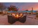 Evening view of backyard fire pit and seating area at 18109 W Juniper Dr, Goodyear, AZ 85338