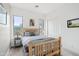 Cozy bedroom with wood bed frame and window views at 18109 W Juniper Dr, Goodyear, AZ 85338