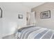 Light and airy bedroom with striped bedding and ensuite access at 18109 W Juniper Dr, Goodyear, AZ 85338