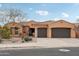 Two-story home with two car garage and desert landscaping at 18109 W Juniper Dr, Goodyear, AZ 85338