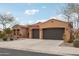 Single-story home with two-car garage and desert landscaping at 18109 W Juniper Dr, Goodyear, AZ 85338