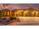 Well-lit two-car garage with desert landscaping at 18109 W Juniper Dr, Goodyear, AZ 85338