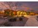 Night view of two story home with landscaped yard at 18109 W Juniper Dr, Goodyear, AZ 85338