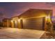 Night view of home exterior with two car garage at 18109 W Juniper Dr, Goodyear, AZ 85338