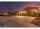 Night view of home exterior with two car garage at 18109 W Juniper Dr, Goodyear, AZ 85338