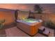 Spacious hot tub with cover open on a brick patio at 18109 W Juniper Dr, Goodyear, AZ 85338