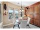 Bright kitchen nook with wood cabinetry and a charming round table set at 18109 W Juniper Dr, Goodyear, AZ 85338