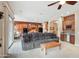 Spacious living room featuring a large gray sectional sofa and a wood coffee table at 18109 W Juniper Dr, Goodyear, AZ 85338