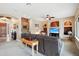 Open living area with built-in shelving, a large sectional sofa, and a media center at 18109 W Juniper Dr, Goodyear, AZ 85338