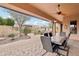 Covered patio with outdoor dining set and ceiling fan at 18109 W Juniper Dr, Goodyear, AZ 85338