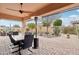 Relaxing covered patio featuring an outdoor dining area and heater at 18109 W Juniper Dr, Goodyear, AZ 85338