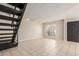 Living room with tile floors, patio doors and staircase at 1817 E Hayward Ave # 3, Phoenix, AZ 85020