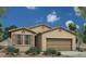 One-story home with tan exterior, tile roof, and landscaping at 18202 W Cielo Grande Ave, Surprise, AZ 85387