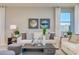 Bright living room with comfy sofas, stylish coffee table, and large windows at 18202 W Cielo Grande Ave, Surprise, AZ 85387