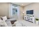 Bright living room with grey sectional sofa and white media console at 18202 W Cielo Grande Ave, Surprise, AZ 85387