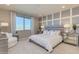 Spacious main bedroom with large window, comfortable seating, and stylish decor at 18202 W Cielo Grande Ave, Surprise, AZ 85387