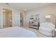 Main bedroom with plush bed, dresser, and comfortable seating area at 18202 W Cielo Grande Ave, Surprise, AZ 85387