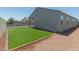 Artificial turf backyard with home and wall at 18972 W Woodlands Ave, Buckeye, AZ 85326