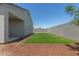 Artificial turf backyard, with a view of the house at 18972 W Woodlands Ave, Buckeye, AZ 85326