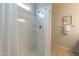 Clean bathroom with shower stall and white tile at 18972 W Woodlands Ave, Buckeye, AZ 85326