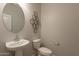 Clean bathroom with pedestal sink and toilet at 18972 W Woodlands Ave, Buckeye, AZ 85326