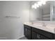 Double vanity bathroom with dark brown cabinets and tiled flooring at 18972 W Woodlands Ave, Buckeye, AZ 85326