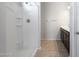 Bathroom with shower stall, tiled flooring and dark brown vanity at 18972 W Woodlands Ave, Buckeye, AZ 85326