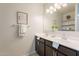 Double vanity bathroom with dark brown cabinets at 18972 W Woodlands Ave, Buckeye, AZ 85326