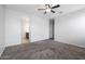 Well-lit bedroom with carpet flooring, and en-suite bathroom access at 18972 W Woodlands Ave, Buckeye, AZ 85326