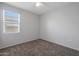 Simple bedroom with carpet, window, and closet at 18972 W Woodlands Ave, Buckeye, AZ 85326