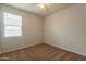 Bedroom with carpet, window, and ceiling fan at 18972 W Woodlands Ave, Buckeye, AZ 85326