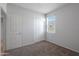 Bright bedroom with carpet flooring, double door closet and window coverings at 18972 W Woodlands Ave, Buckeye, AZ 85326