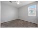 Simple bedroom with carpet, window, and neutral walls at 18972 W Woodlands Ave, Buckeye, AZ 85326