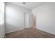 Simple bedroom with carpet, window, and closet at 18972 W Woodlands Ave, Buckeye, AZ 85326