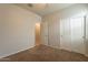 Bedroom with carpet, double door closet, and access to bathroom at 18972 W Woodlands Ave, Buckeye, AZ 85326