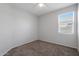 Spacious bedroom with carpet flooring and window at 18972 W Woodlands Ave, Buckeye, AZ 85326