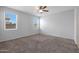 Spacious bedroom featuring carpet flooring and ceiling fan at 18972 W Woodlands Ave, Buckeye, AZ 85326