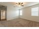 Bright bedroom with ceiling fan and carpet at 18972 W Woodlands Ave, Buckeye, AZ 85326