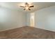 Main bedroom with ceiling fan and ensuite bathroom at 18972 W Woodlands Ave, Buckeye, AZ 85326