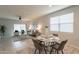 Bright dining area with seating for four and adjacent living room at 18972 W Woodlands Ave, Buckeye, AZ 85326