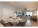 Open concept dining area with seating for four, near living room at 18972 W Woodlands Ave, Buckeye, AZ 85326