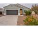 Gray house with a two-car garage and desert landscaping at 18972 W Woodlands Ave, Buckeye, AZ 85326