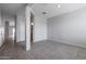 Clean hallway with tile floor and access to bathroom at 18972 W Woodlands Ave, Buckeye, AZ 85326