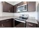 Stainless steel appliances and granite countertops in a modern kitchen at 18972 W Woodlands Ave, Buckeye, AZ 85326